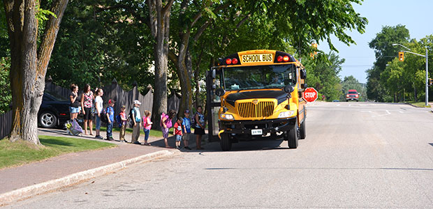 Children lining up for the school bus